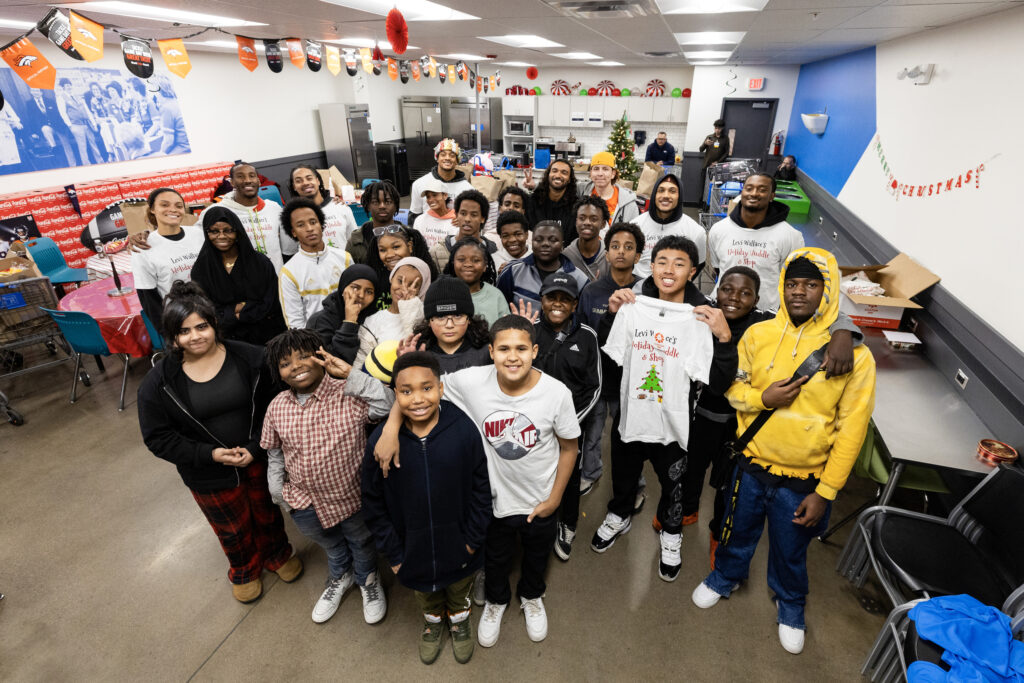 A group photo during a holiday shopping event with the Levi Wallace Foundation at  in Aurora, Colorado on December 9, 2024. Photo by Ben Swanson / Denver Broncos
